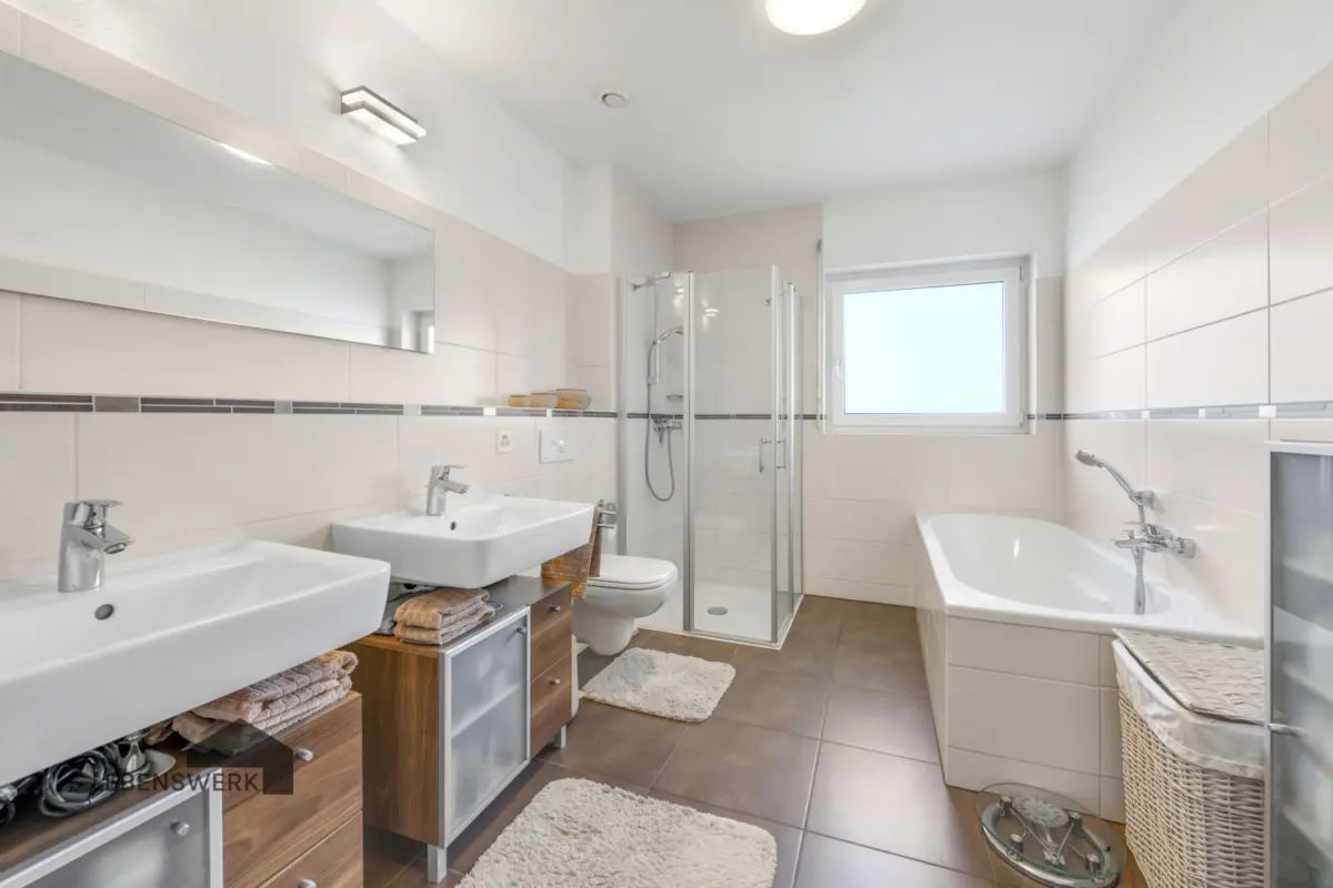 Grosses Badezimmer mit Badewanne und Eckdusche